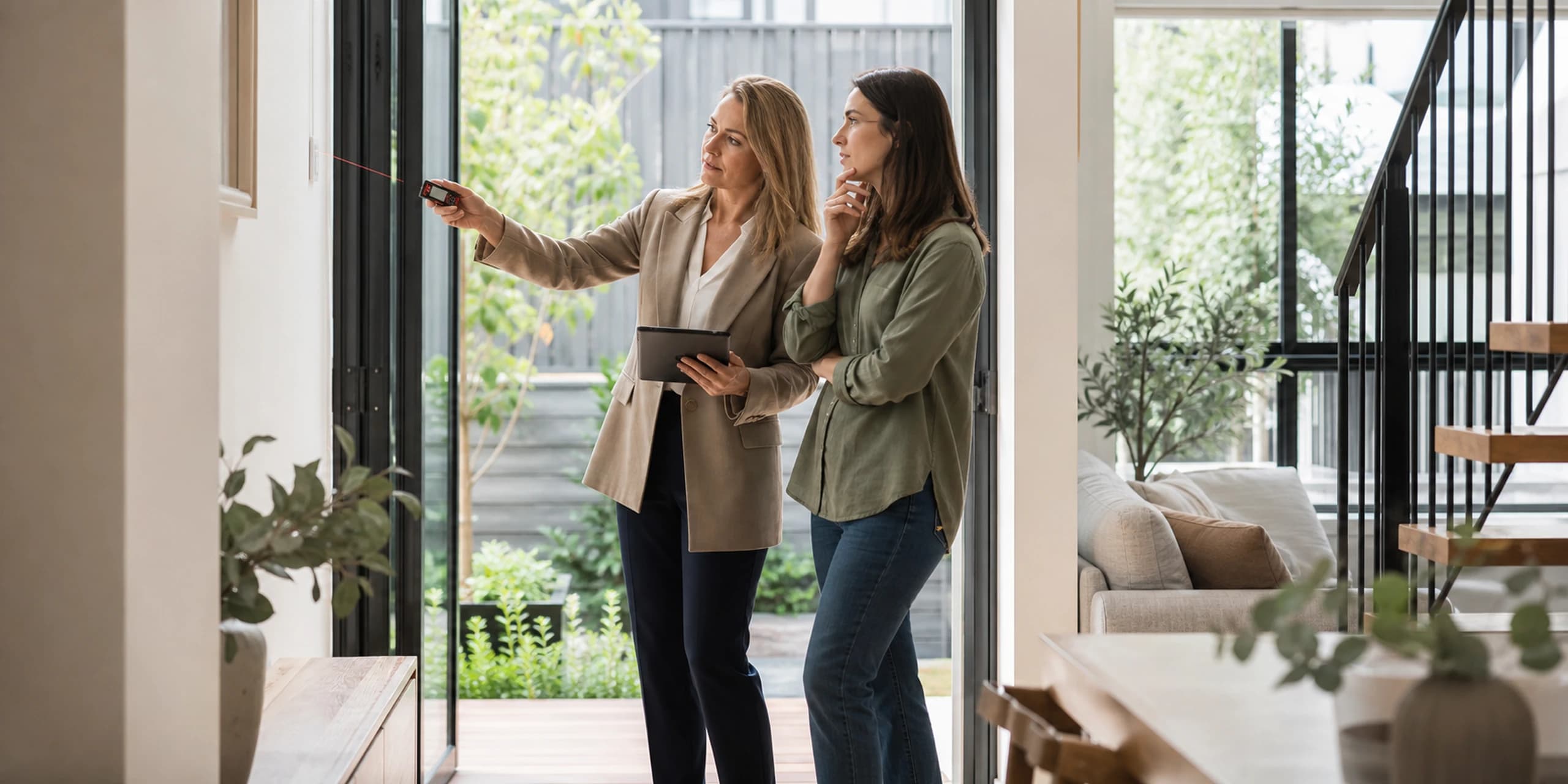 Independent valuer inspecting a townhouse while a prospective buyer observes